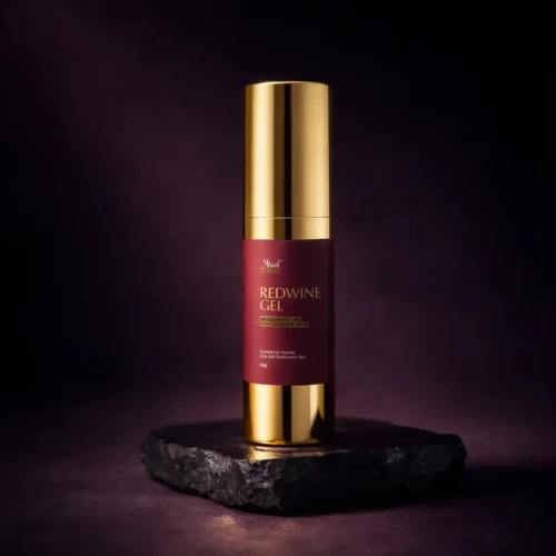Araah Red Wine Gel bottle with gold pump placed on dark stone platform, premium skincare product for oily and combination skin