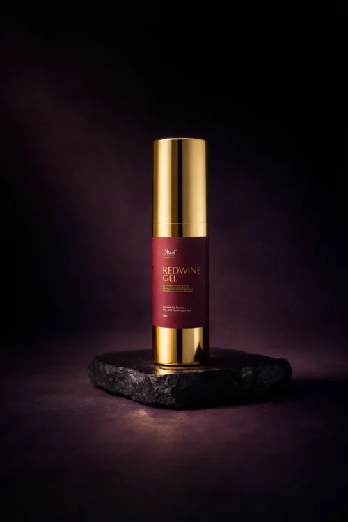 Araah Red Wine Gel bottle with gold pump placed on dark stone platform, premium skincare product for oily and combination skin